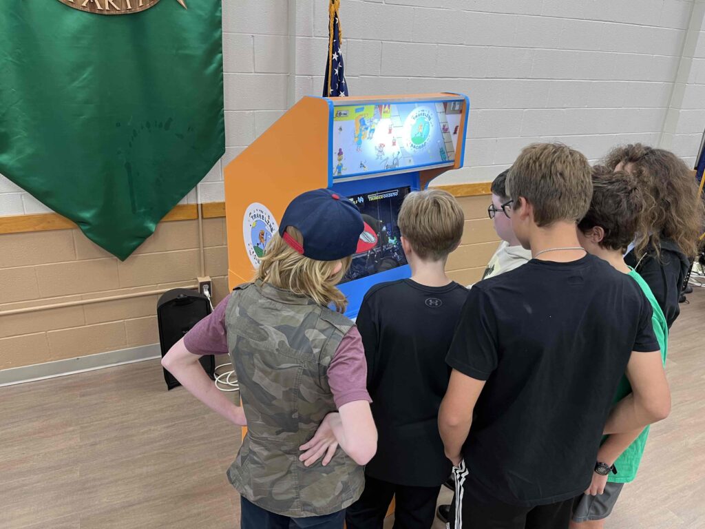 Students gather around to watch a Killer Instinct match.